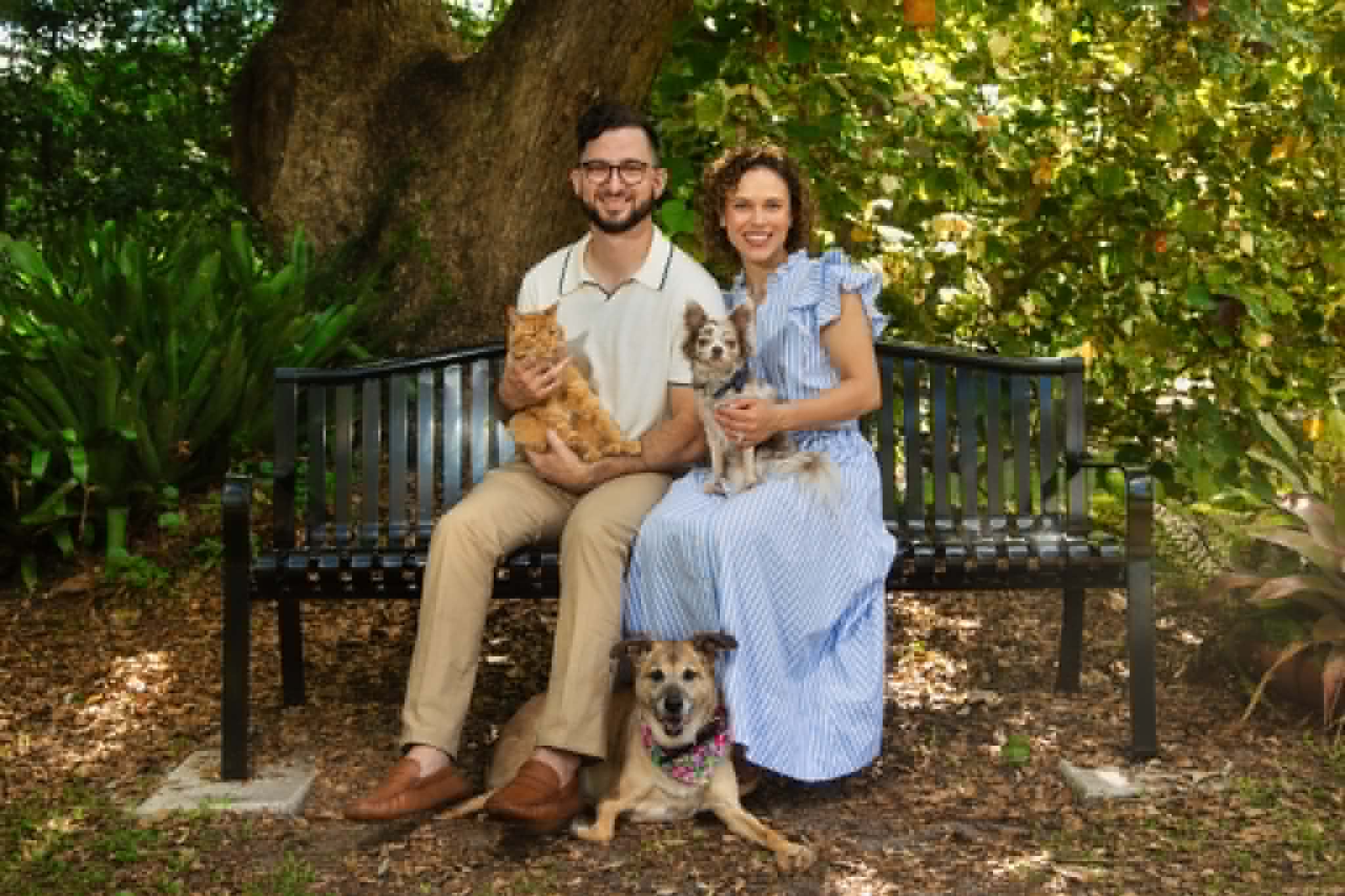 Dr. Natalia Martinez with her family and pets on an outdoor bench
